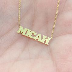 "This unique personalized block font single name cut-out necklace is composed of 14K solid gold and beautifully complemented by a durable 14K solid gold adjustable chain. This design is also available to be purchased as a charm alone without the chain. NOTE: The item will be made in the exact casing of the characters entered. Please be mindful of this detail when providing the customization desired. ♦Name Dimensions: approximately 3 to 4mm high x width depending on the names desired ♦ Pendant Th 14k Gold Nameplate Necklace With Initials, Gold Initials Nameplate Necklace, Gold Nameplate Necklace With Initials, Yellow Gold Custom Name Necklace With Initial Pendant, Custom Yellow Gold Nameplate Necklace With Initials, Custom Name 14k Yellow Gold Name Necklace, Custom Name Yellow Gold 14k Name Necklace, Custom Name 14k Yellow Gold Necklace, Custom Name Yellow Gold 14k Necklace