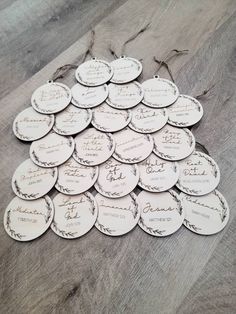 a pile of white tags sitting on top of a wooden table