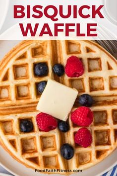 a waffle topped with berries and butter on top of a white plate next to a fork