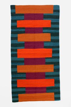 an orange, blue and green striped rug on a white background with horizontal lines in the middle