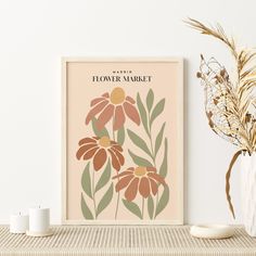 a flower market poster on a shelf next to some candles