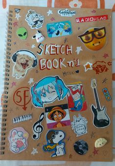 a spiral notebook with stickers on it