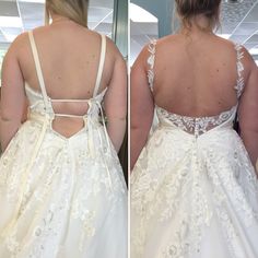 the back of a bride's dress as she stands in front of a mirror