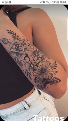 a woman's arm with flowers on it and the words tattoos written in black ink