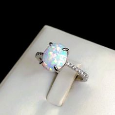 White Fire Opal Sterling Silver Ring, Cabochon Opal Ring, Fire Opal Engagement Ring, White Opal, Minimalistic Ring, Stacking Ring, Wedding Ring. 💎 Gemstones: 8*10mm Conflict-free Cabochon Fire-Opal (Origin Mexico) set with clear Topaz.  💎 Base Material: Solid Sterling Silver (925) or your choice of precious metal.  💎 Stamps / Markings: 925 (for silver version) 💎 Please note Sterling Silver is in ready stock for immediate dispatch. All Gold or Platinum versions are made to order with approxim Opal Rings With Gemstone Accents, White Opal Ring With Stone Setting As A Gift, White Opal Ring With Gemstone Accents As Gift, White Crystal Promise Ring With Stone Setting, White Opal Jewelry With Accent Stones, Adjustable White Round Cut Crystal Ring, White Opal Ring With Gemstone Accents, White Multi-stone Round Cut Opal Ring, Fine Jewelry White Rings With Gemstone Accents