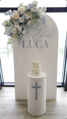 a cake sitting on top of a table next to a sign