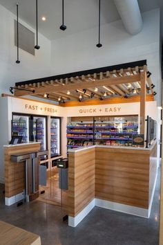 the interior of a fast food restaurant with wood accents