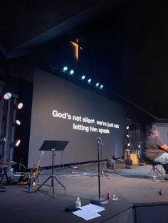 a man sitting in a chair on top of a stage