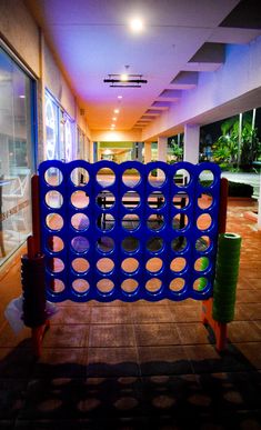 a giant blue board game in the middle of a hallway