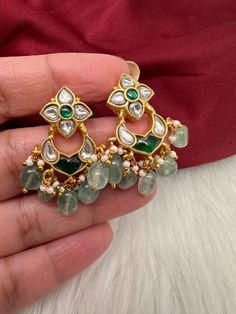 Jadau Kundan Dainty Earrings screwback earringsColor : GoldenSize : Length : 1.5 Inches; Weight : 8 grams eachStones : Green Jadau Kundan Pearls Green Beads Jadau Earrings, Green Beads, Dainty Earrings, Social Events, Green Bead, Indian Jewelry, Beads, Stone, Green