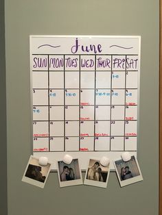 a calendar hanging on the wall with photos pinned to it