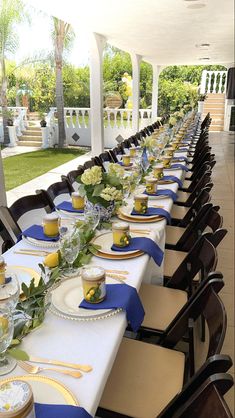 a long table is set with blue and white plates