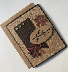 a close up of a greeting card on a white surface with an embossed background