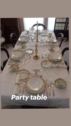 the table is set with silver and gold china