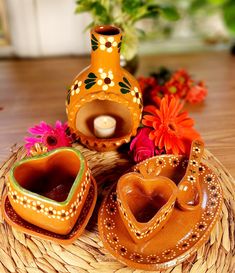 three decorative vases sitting on top of a basket