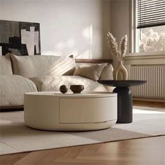 a living room with white furniture and pillows