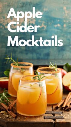 three glasses filled with cider cocktails on top of a wooden table