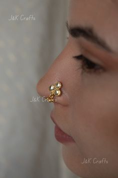 Delicate nosepin worked in gold plated silver alloy and encrusted with kundan and embellished with gold plated beads. This nosepin is the perfect piece to complete your ethnic attire. Closure - Push Wire Size - 1 cm Style Tip - This nosering is a perfect amalgam of tradition that meets new age minimalism. Offering a rich traditional experience full of opulence and deeply rooted in culture, this nosepin is sure to become your favourite jewelry staple. Handcrafted in Jammu and Kashmir Paisley Pop Gold Nose Studs For Wedding, Elegant Nose Studs For Weddings, Elegant Gold Nose Studs For Wedding, Elegant Round Nose Studs For Wedding, Elegant Wedding Nose Studs, Elegant Round Wedding Nose Studs, Rakhi Design, Jewelry Staples, Stone Choker