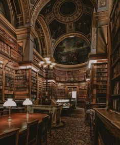 an old library with many books on the shelves and two lamps in front of them