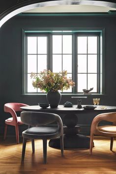 two chairs and a table in front of a window