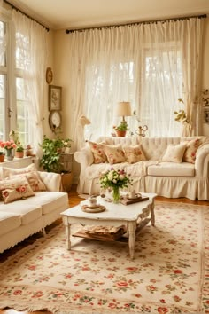 a living room filled with lots of furniture and flowers in vases on the coffee table