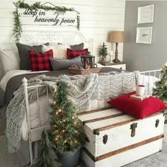 a bedroom decorated for christmas with white and red accents