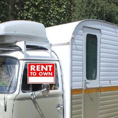 an old camper with a rental sign on the front door and another trailer behind it