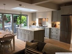 an open kitchen and living room with sliding glass doors leading to the outside deck area