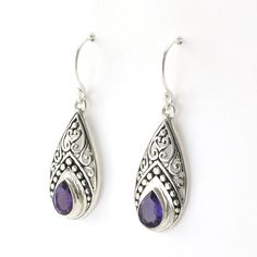 Handmade sterling silver amethyst tear shaped dangle earrings are 1 7/16 inches long and 7/16 inch wide. Earrings come with a pair of clear rubber earring stoppers for the ear wires. Style Number: 15645 Metal: 925 Sterling Silver Gemstone: Genuine Amethyst Dimensions: 1 7/16 inches long and 7/16 inch wide Handmade in Bali, Indonesia Purple Sterling Silver Teardrop Dangle Earrings, Purple Sterling Silver Teardrop Earrings For Gift, Teardrop Amethyst Earrings For Pierced Ears, Amethyst Teardrop Earrings For Pierced Ears, Sterling Silver Gemstone Teardrop Pendant Earrings, Purple Sterling Silver Teardrop Earrings, Classic Teardrop Purple Earrings, Nickel Free Teardrop Purple Earrings, Sterling Silver Gemstone Teardrop Earrings