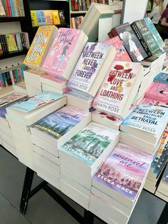 many books are stacked on top of each other at the library's book sale