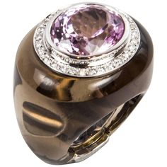 A Show Stopper! Stylish and finely detailed Ring featuring an oval shaped natural pastel purplish pink Kunzite; approx. 12ct. (16mm x 13.5mm) surrounded by 0.40 Carats of Diamonds; enveloped in smoky quartz; unique stunning design, hand crafted in 18K white gold; Excellent workmanship; ring size 8 (with installed sizing spring bar); top front measures 30 x 26 mm; total weight: 33.23gm. This ring is in excellent condition and was recently professionally cleaned and polished. Outstanding…A Runway Couleur Rose Pastel, Diamond Bracelet Design, White Gold Diamond Earrings, Pink Kunzite, Platinum Diamond Rings, Gold Statement Ring, Gold Cocktail Ring, Pendant Watches, Rose Pastel