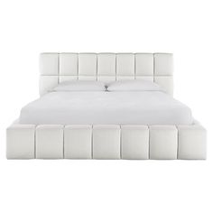 the bed is made with white linens and has an upholstered headboard