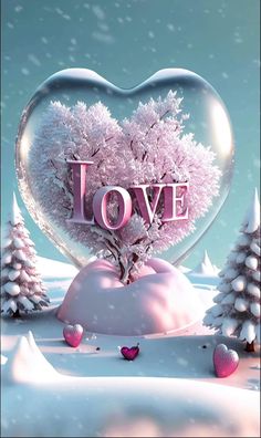 a heart - shaped object with the word love in it surrounded by trees and snow