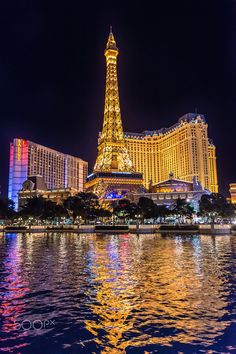 the eiffel tower is lit up at night in las vegas, nv