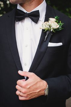 a man in a tuxedo with a boutonniere on his lapel