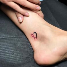 a woman's foot with a small tattoo on the left side of her leg