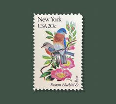 a stamp with two birds on it and flowers in the foreground, against a green background