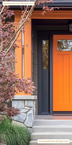 an orange front door and steps leading to a house with trees in the foreground