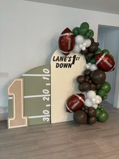 balloon arch with footballs and balloons on it