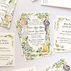 the wedding stationery is laid out on top of each other