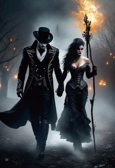 a man and woman dressed up as witches walking through the woods with torches in their hands