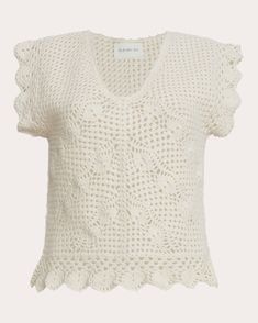 a white knitted top with ruffles on the shoulders