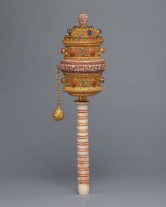 an elaborately decorated pole with a bell on it