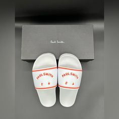 An Essential Piece For The Warmer Weather, These White/Orange Summit Face Slides Sandals Are Perfect For Regular Use. Made In Portugal, These Slides Feature Our Ps Paul Smith Logo. Finished With A Smooth Footbed For Comfort And Grippy Patterned Outsole. Made In Portugal 100% Rubber. Us Sizes: Us Sizes 6-7 Are Small Sizes. Us Sizes 8-9 Are Medium Sizes. Us Sizes 11-12 Are Xl Sizes. White Non-slip Sandals For Streetwear, Non-slip White Sandals For Streetwear, White Flat Sandals For Streetwear, White Slip-on Sandals For Streetwear, Paul Smith Shoes, Slides Sandals, Paul Smith, Slide Sandals, Flip Flop Sandals