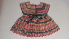 This dress is made from yarn by knitting with needles by hand. Cute Fitted Knit Dress, Handmade Fitted Pink Dress, Cute Multicolor Winter Dresses, Cute Handmade Pink Dress, Hand Knitted Cotton Dresses In Cute Style, Cute Hand Knitted Cotton Dresses, Cute Handmade Spring Dress, Hand Knitted Cute Cotton Dresses, Hand-knitted Cotton Dresses In Cute Style