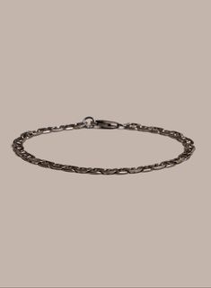 This is the perfect bracelet for the guys who prefer not only the minimalist look but also the minimalist weight. This super sleek double anchor chain has a thickness of only 1.5mm making it very lightweight and easy to wear. The chan has a light gunmetal rhodium coating for just a tad of extra shine. Chain width: 5mm Material: Rhodium over 925 Sterling Silver Clasp: Oxidized Sterling Silver. Lobster claw. Available in size 7in, 8in, 9 inches. Feel to reach us for any custom sizing. Minimalist Silver Cable Chain Bracelets, Modern Everyday Rolo Chain Bracelet, Sterling Silver Rolo Chain Bracelet For Everyday, Modern Sterling Silver Rolo Link Bracelet, Black Oxidized Metal Chain Bracelet, Masculine Silver Bracelets With Stainless Steel Clasp, Luxury Men's Chain Bracelet With Sterling Silver Clasp, Mens Designer Jewelry, Mens Chain Bracelet Jewelry1000.com