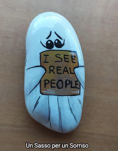 a painted rock that says i see real people with a box in the shape of a ghost