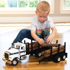 a young boy playing with toy trucks on the floor