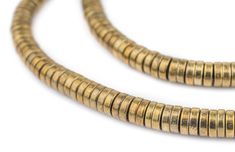 two gold toned beads on a white background