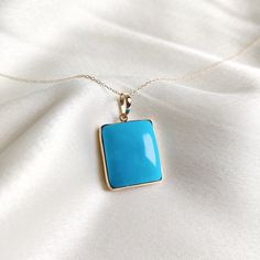 This stunning pendant is set in 14K Solid Yellow Gold with Natural Sleeping Beauty Arizona Turquoise with utmost precision. It is an unique gemstone pendant for nearly every occasion and is completely hassle-free jewelry. ITEM DETAILS * Gem: Turquoise * Gem Size: 17X20mm * Gem Shape: Rectangle Cab  * Gem Weight: 30.52 carats * Gold Purity: 14KT  * Gold Weight: 1.442 gram * Total Weight of the Pendant: 7.546 gram The Gold purity is guaranteed and it comes with authentic 14KT gold hallmark. Since my items are handmade, they are absolutely nickel and lead free. CUSTOMIZATION * Gemstone customization is available and it can be substituted with a gem of your choice. Kindly message me for the same. PACKAGING * The Pendant comes with layers of safe and secure wrapping along with Free handmade jew Fine Jewelry Turquoise Pendant, Fine Jewelry Turquoise Pendant Necklace, Fine Jewelry Turquoise Pendant Necklace Gift, Turquoise 14k Gold Fine Jewelry, Fine Jewelry In 14k Gold With Turquoise, 14k Gold Turquoise Fine Jewelry, Turquoise Gemstone Rectangular Pendant Jewelry, Turquoise Pendant Fine Jewelry, Elegant Turquoise Necklace With Rectangular Pendant